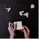 Hands working on a device or document, representing professional results delivered to clients.